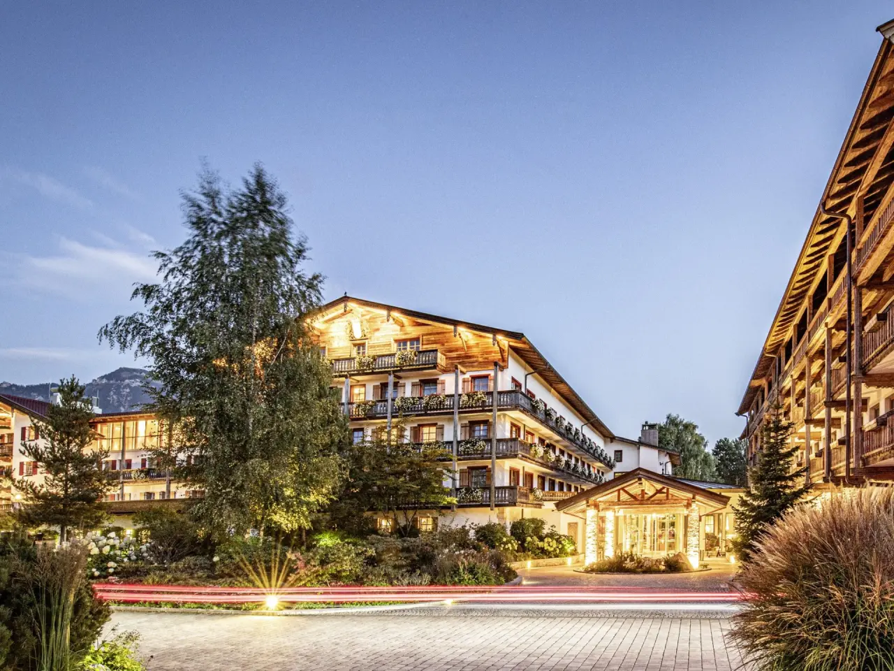 Abendliche Aussenansicht des DAS ACHENTAL Hotels. Traditionelle Architektur mit beleuchteter Fassade und einladendem Eingangsbereich.