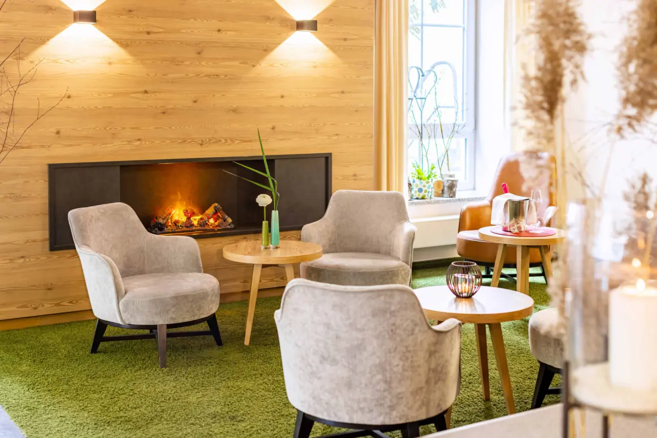 Gemütliche Lounge mit Kamin und bequemen Sesseln im Best Western Plus Parkhotel Maximilian, ideal zum Entspannen.