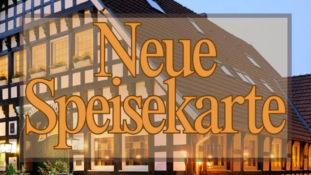 Aussenansicht des Vila Vita Burghotel Dinklage mit Fachwerkfassade und dem Schriftzug 'Neue Speisekarte'.