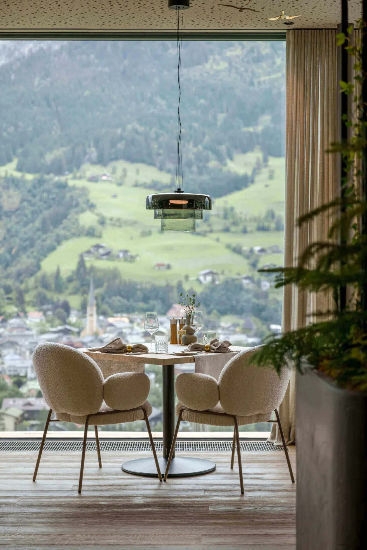 Stilvolles Restaurant im DAS.GOLDBERG mit Panoramablick auf die grüne Berglandschaft und das Tal.