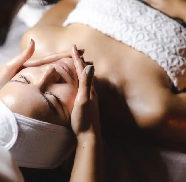 Frau genießt entspannende Gesichtsbehandlung im Spa-Bereich des Hotel Post Ischgl.