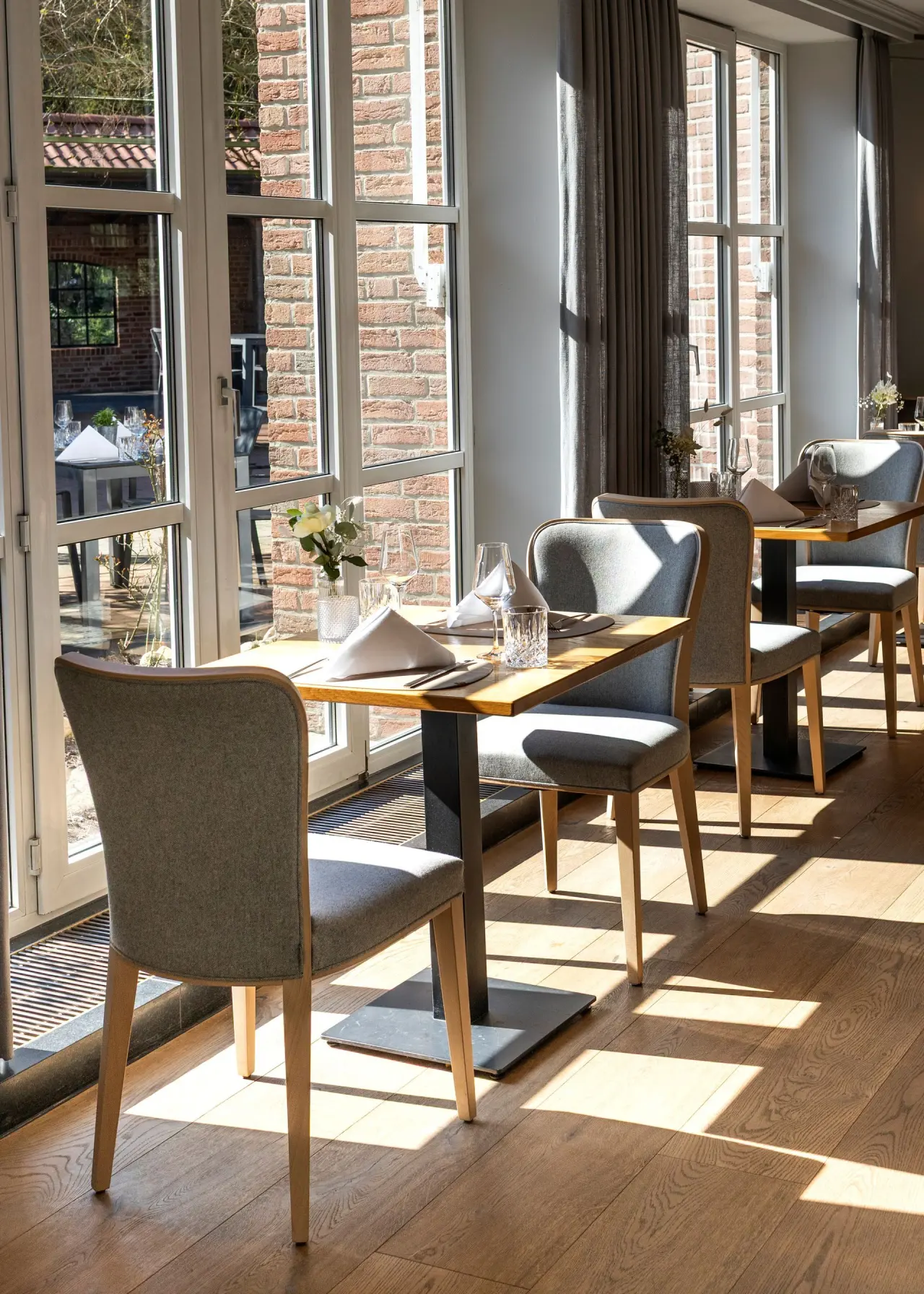 Hotel Heidegrund in Garrel – Helles Restaurant mit elegant gedeckten Tischen am Fenster | Wellnesshotel Garrel