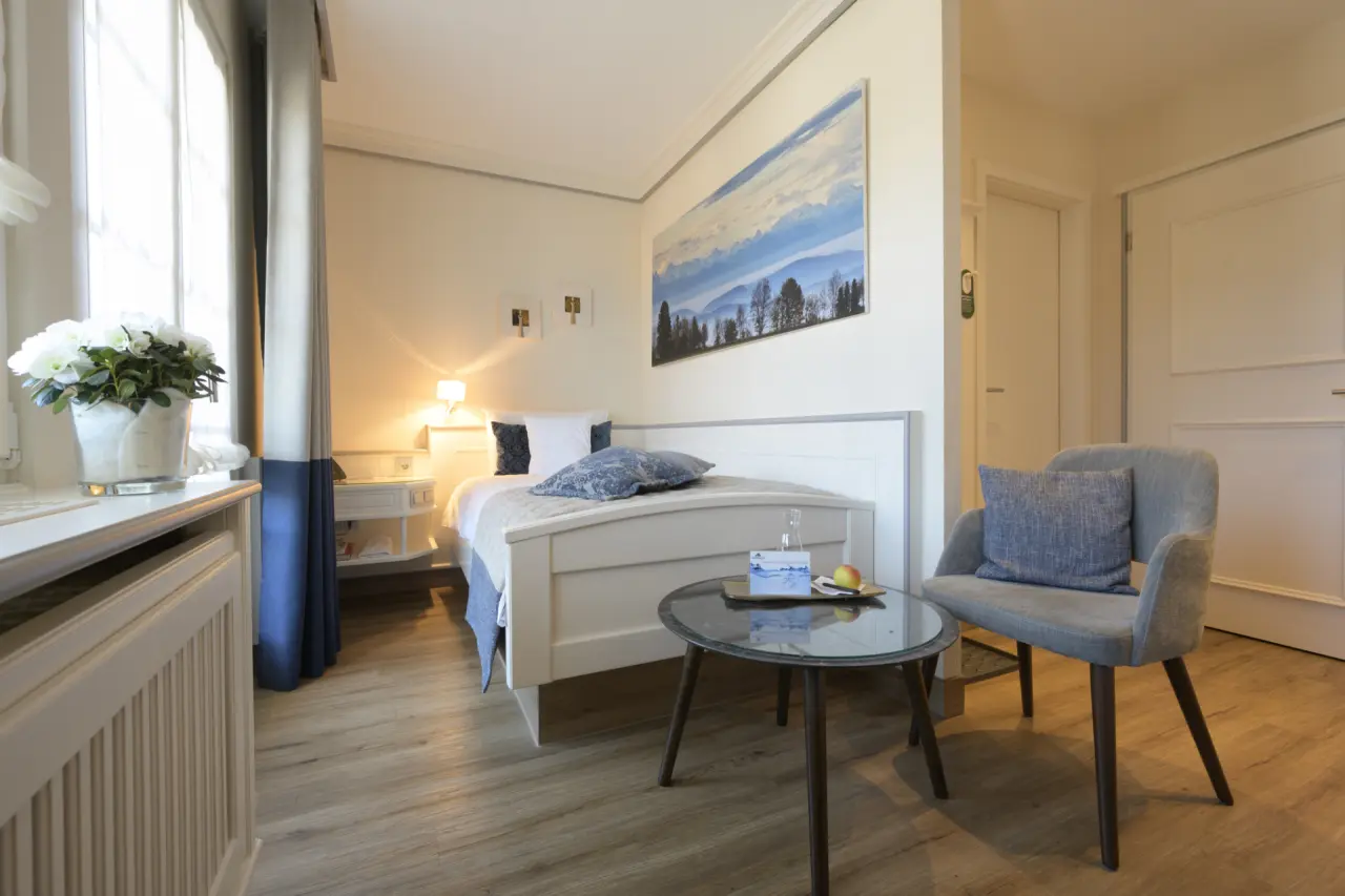 Helles, modern eingerichtetes Hotelzimmer mit Einzelbett und Sitzgelegenheit im Bio- und Wellnesshotel Alpenblick.