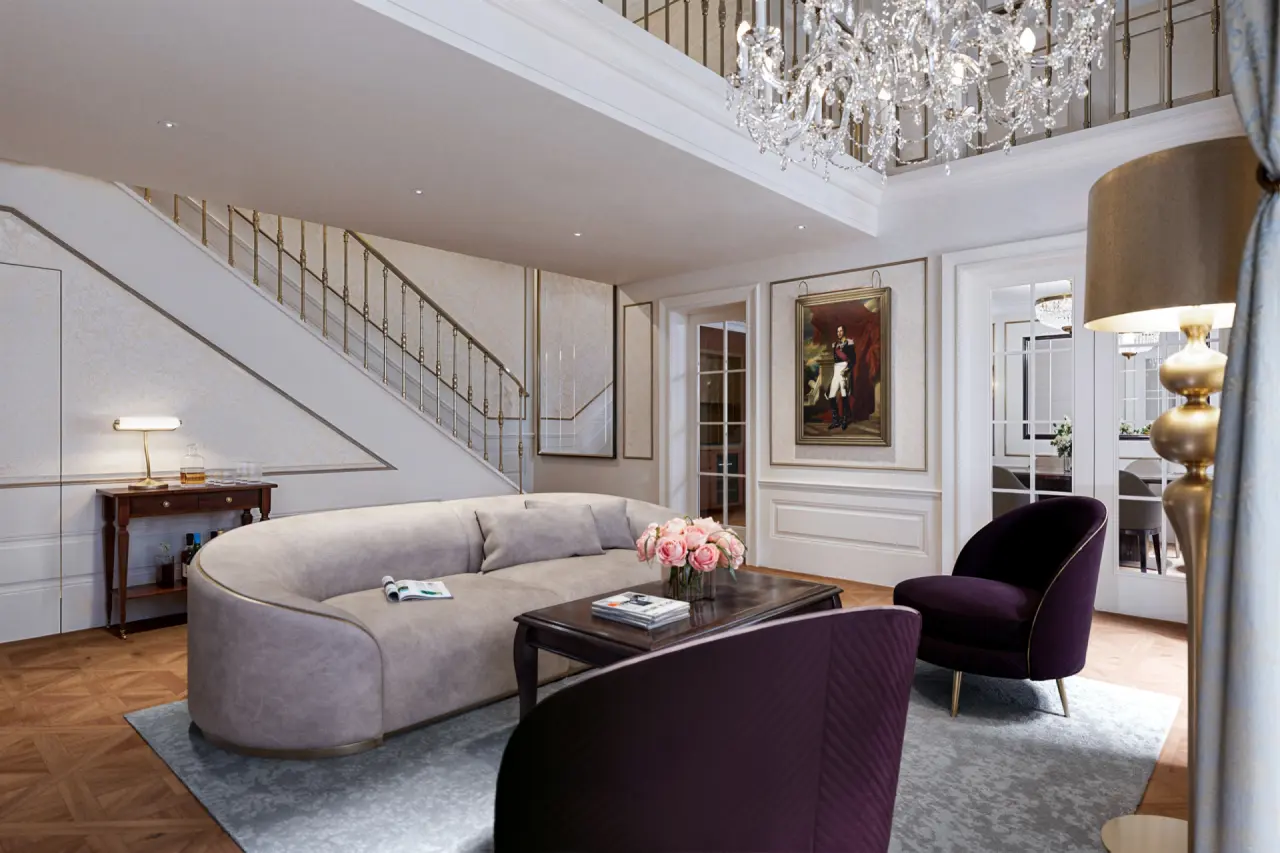 Elegante Lobby mit prunkvollem Kronleuchter, geschwungener Treppe und luxuriösen Sitzbereichen im Palais Coburg Residenz.