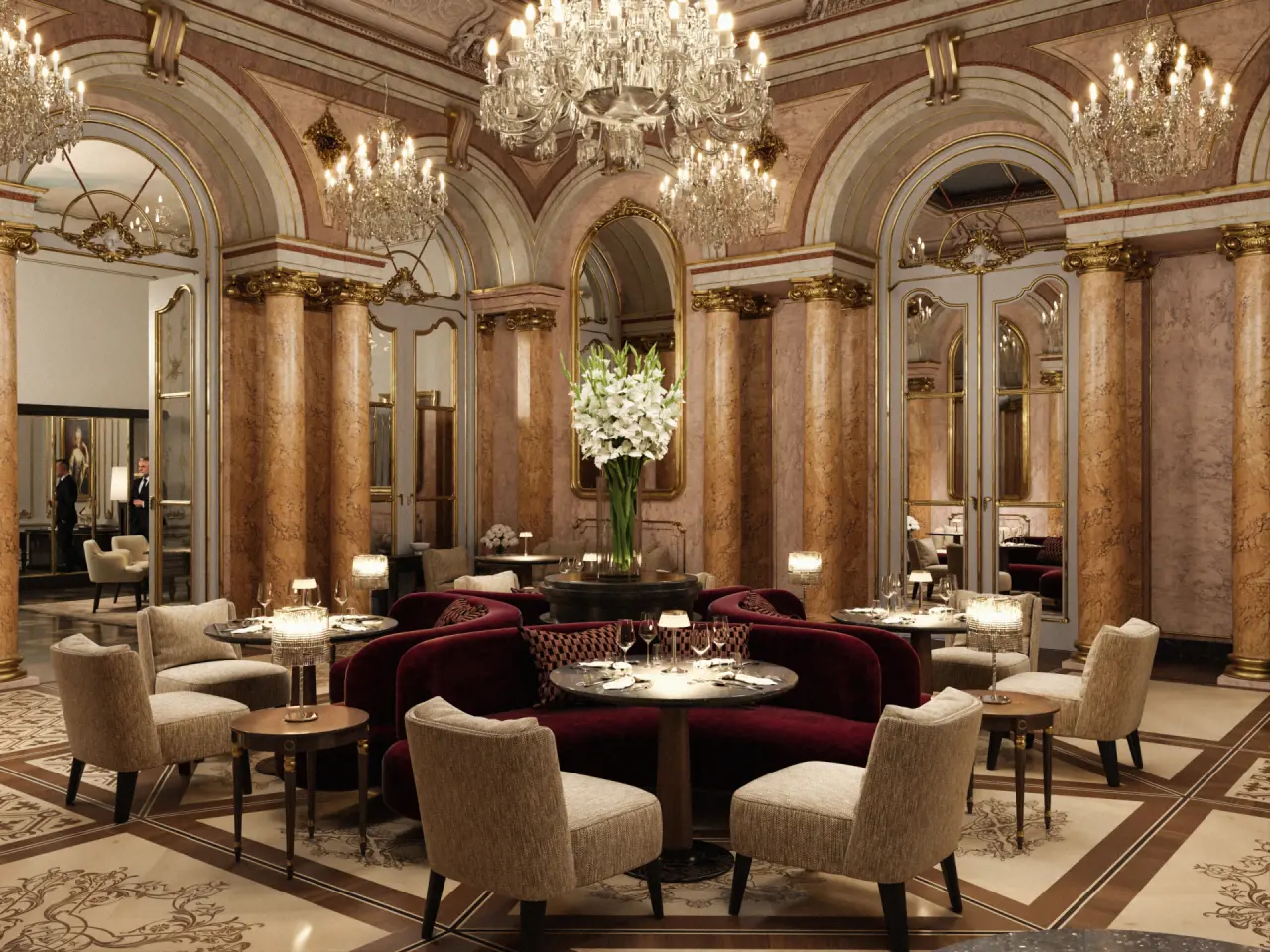 Opulenter Lounge- und Restaurantbereich im Palais Coburg Residenz mit Kronleuchtern, Marmorsäulen und eleganten Sitzgruppen.