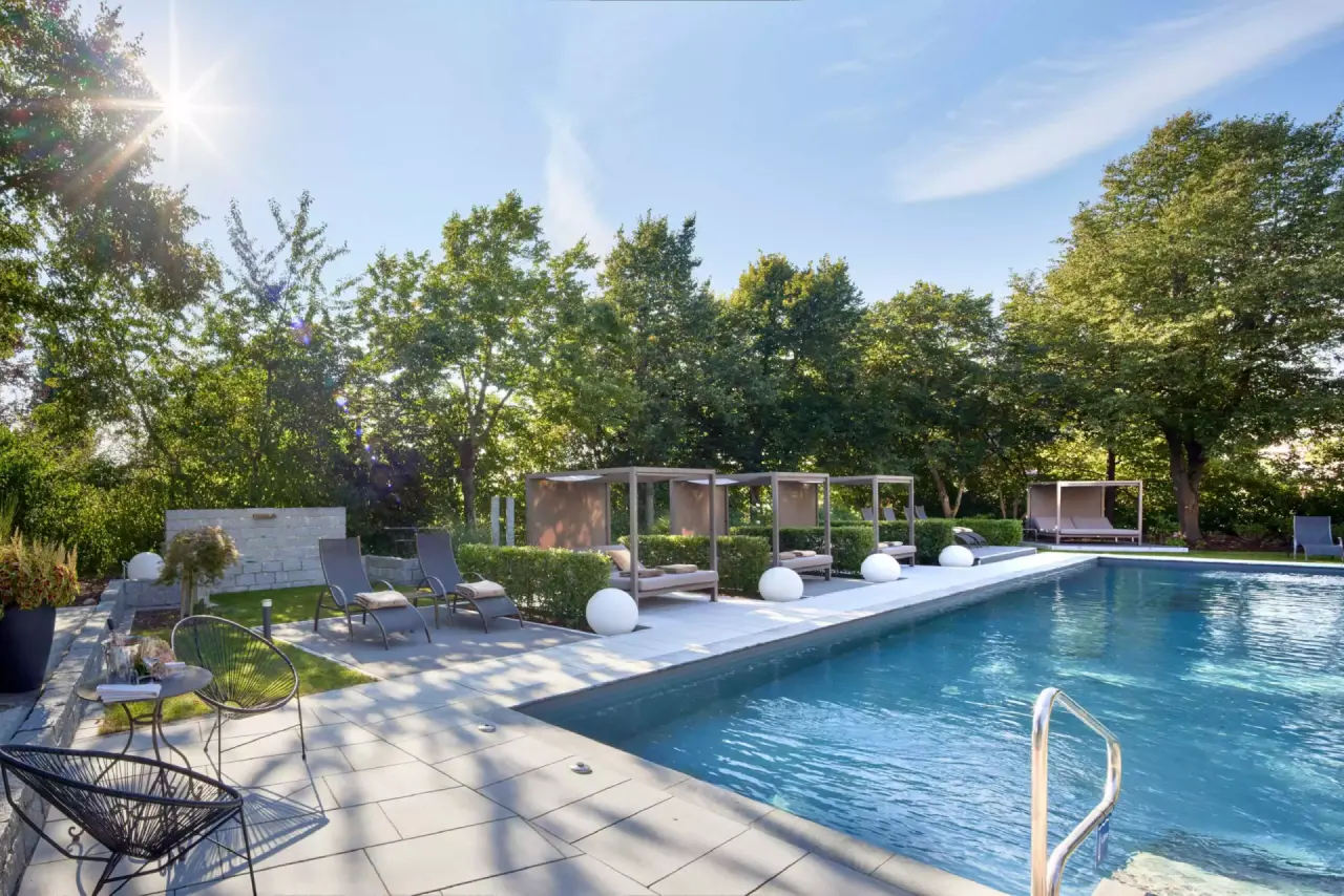 Grosszügiger Aussenpool mit luxuriösen Cabanas und Liegen im Garten des Götzfried**** Kultur- und Spahotels.