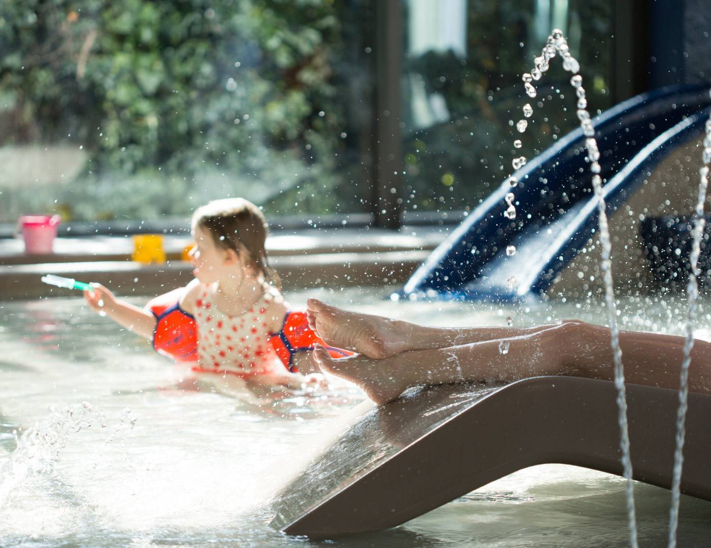 SPA & Relax Hotel Erika in Dorf Tirol – Kind spielt im flachen Kinderbecken mit Wasserspritzern | Wellnesshotel Südtirol