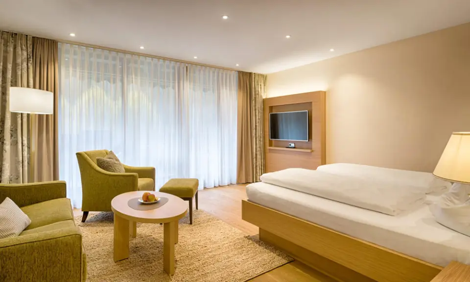 Gemütliches Doppelzimmer im Hotel Thomahof mit modernem Design, bequemer Sitzecke und großem Fenster.