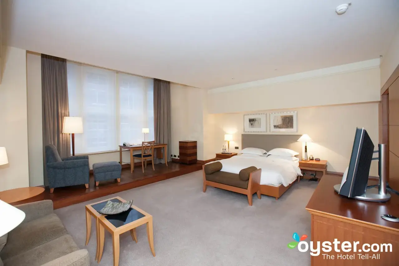 Geräumiges Hotelzimmer mit Doppelbett, Schreibtisch und Sitzbereich im Park Hyatt Hamburg.