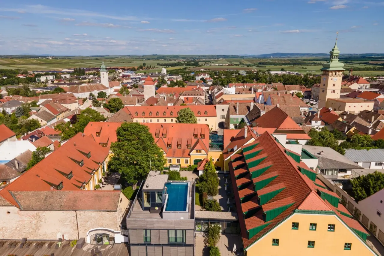 Luftaufnahme des Hotel Althof Retz mit Rooftop-Pool und Blick über die historische Stadt Retz und die umliegende Landschaft.
