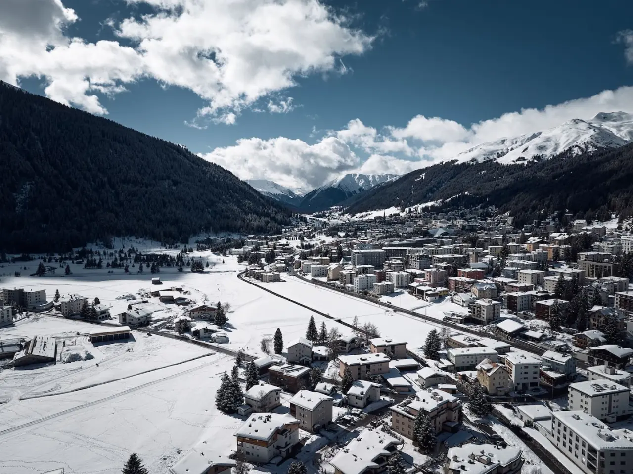 Winterliches Panorama von Davos mit verschneiten Bergen und dem Tal, die malerische Umgebung des Precise Tale Seehof Davos.