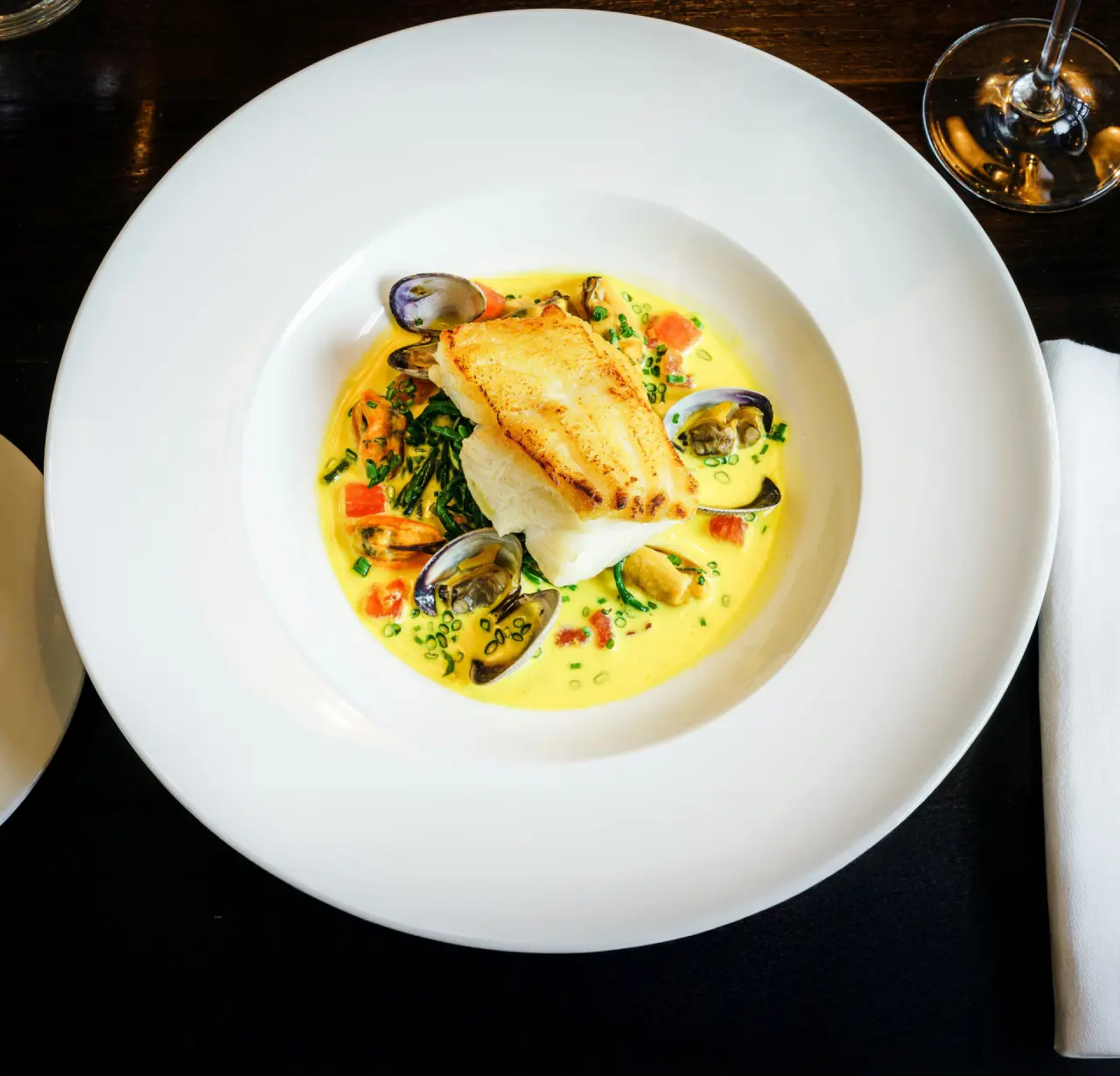 Exquisites Fischgericht mit Muscheln und Safransauce im Restaurant des Hotel Krone Au.