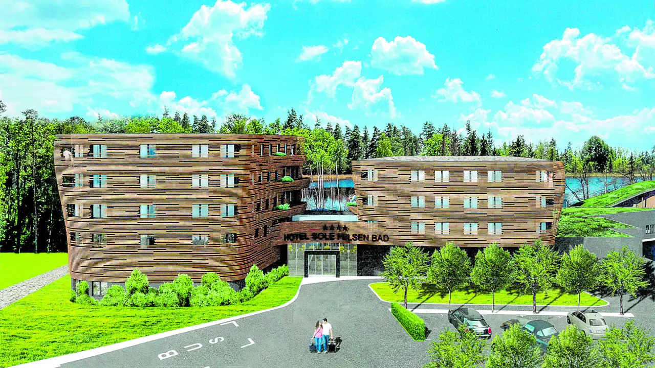 Aussenansicht des modernen Hotel Sole Felsen Welt mit Holzfassade, umgeben von Wald und einem See.