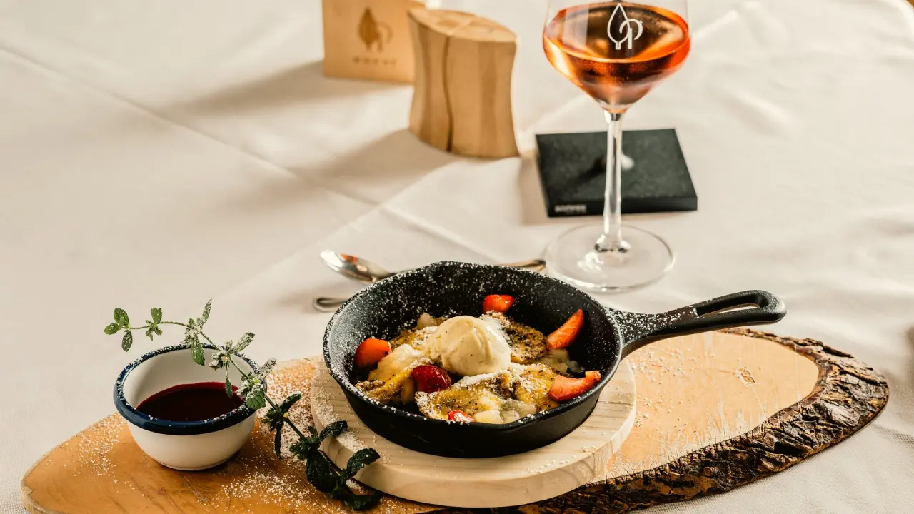 Kaiserschmarrn mit Erdbeeren und Vanilleeis in einer Pfanne im Restaurant des Das Parkhotel.