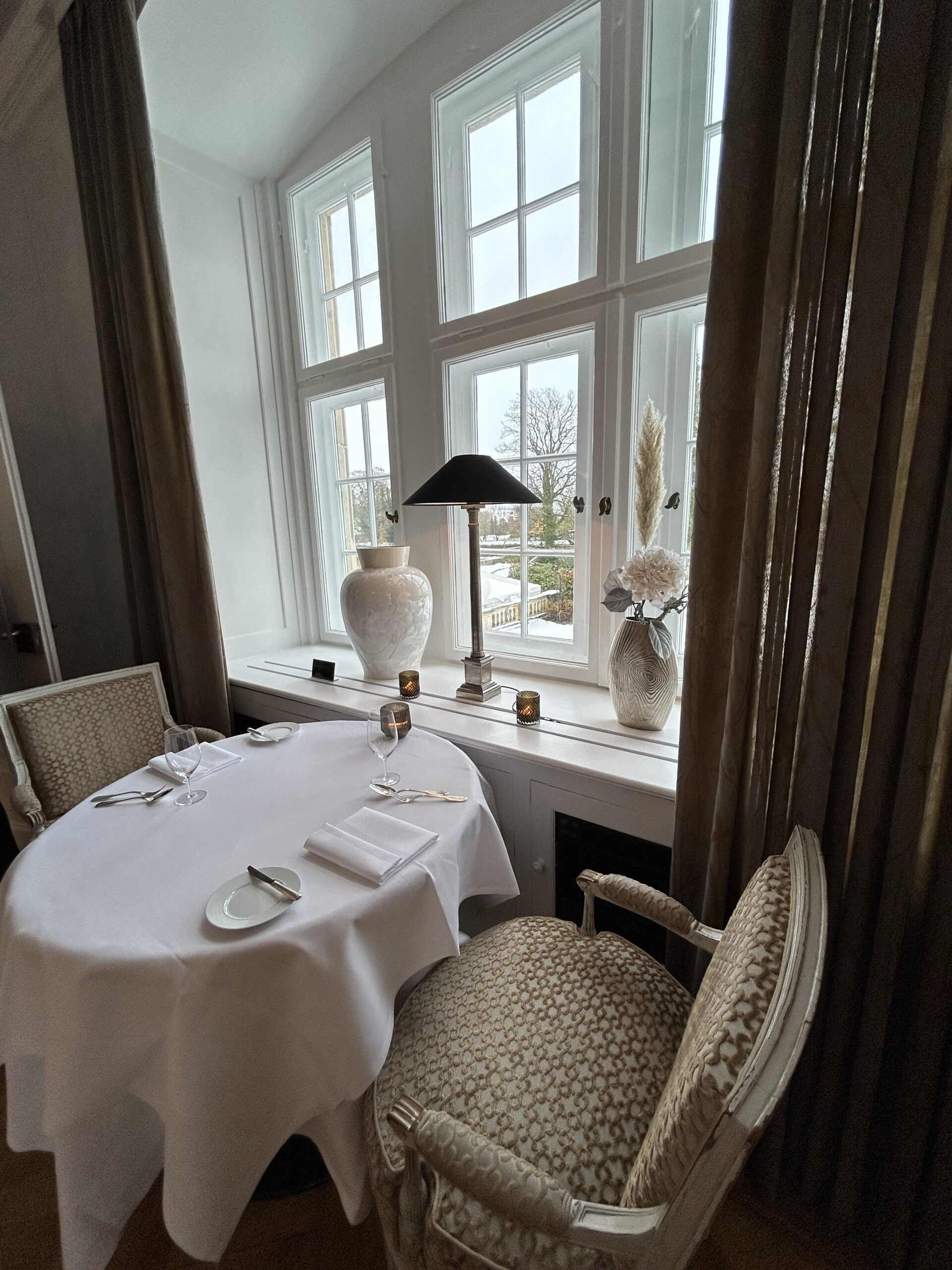 Schlosshotel Münchhausen in Aerzen – Elegantes Restaurant mit Tisch am Fenster | Wellnesshotel Weserbergland