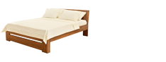 Bett mit cremefarbener Bettwäsche im Hotel Am Hirschhorn.