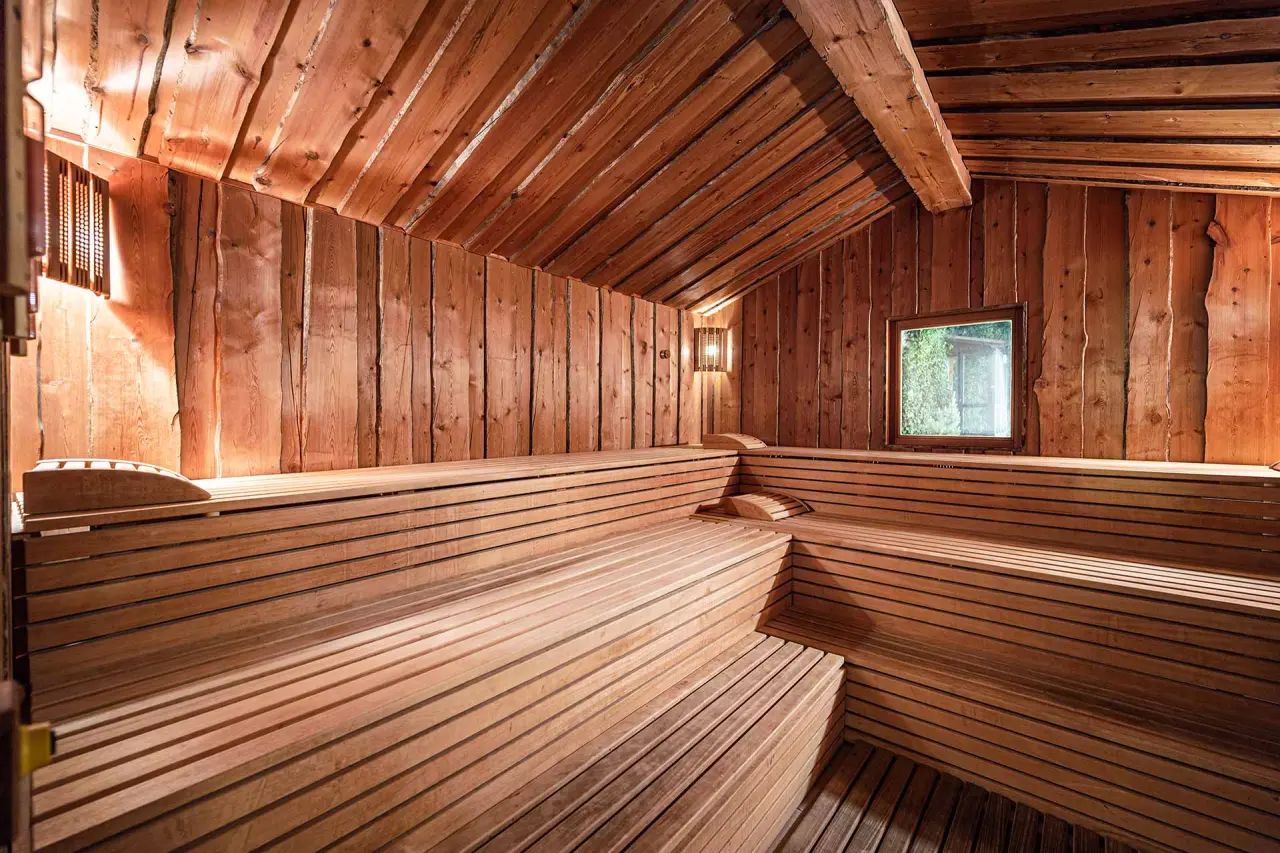 Mittelburg Wellnesshotel in Oy-Mittelberg – Traditionelle Holzsauna mit Fenster und warmem Licht | Wellnesshotel Allgäu