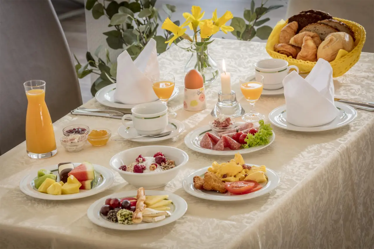 Reichhaltiges Frühstück mit frischen Früchten, Müsli, Aufschnitt und Gebäck im HofHotel Krähenberg.