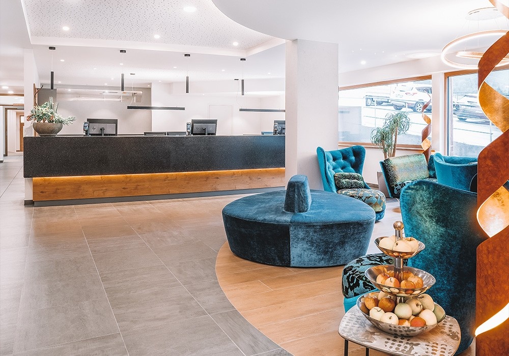 Hotel Kaiserblick in Ellmau – Stilvolle Lobby mit Rezeption und gemütlichen Sitzbereichen | Wellnesshotel Tirol