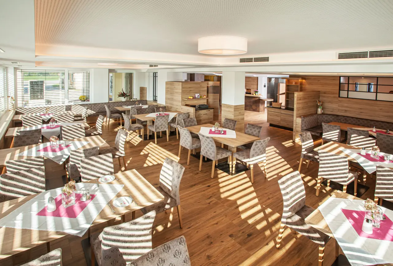 Heller, modern eingerichteter Restaurantbereich im Hotel Gasthof Enichlmayr mit Holzböden und Tischen, bereit für Gäste.