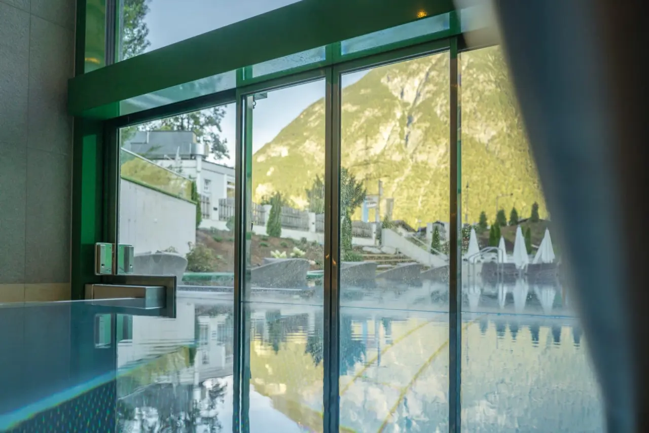 Grosszügiger Innenpool mit beeindruckendem Bergblick im Wellnessbereich des Hotel Jägerhof.