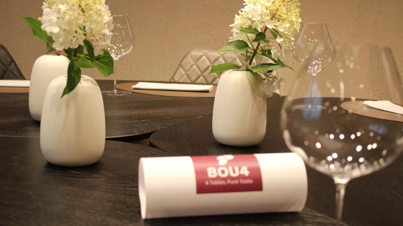 Elegant gedeckter Tisch mit Blumenvasen und Weingläsern im Restaurant des Hotel Jägerhof.