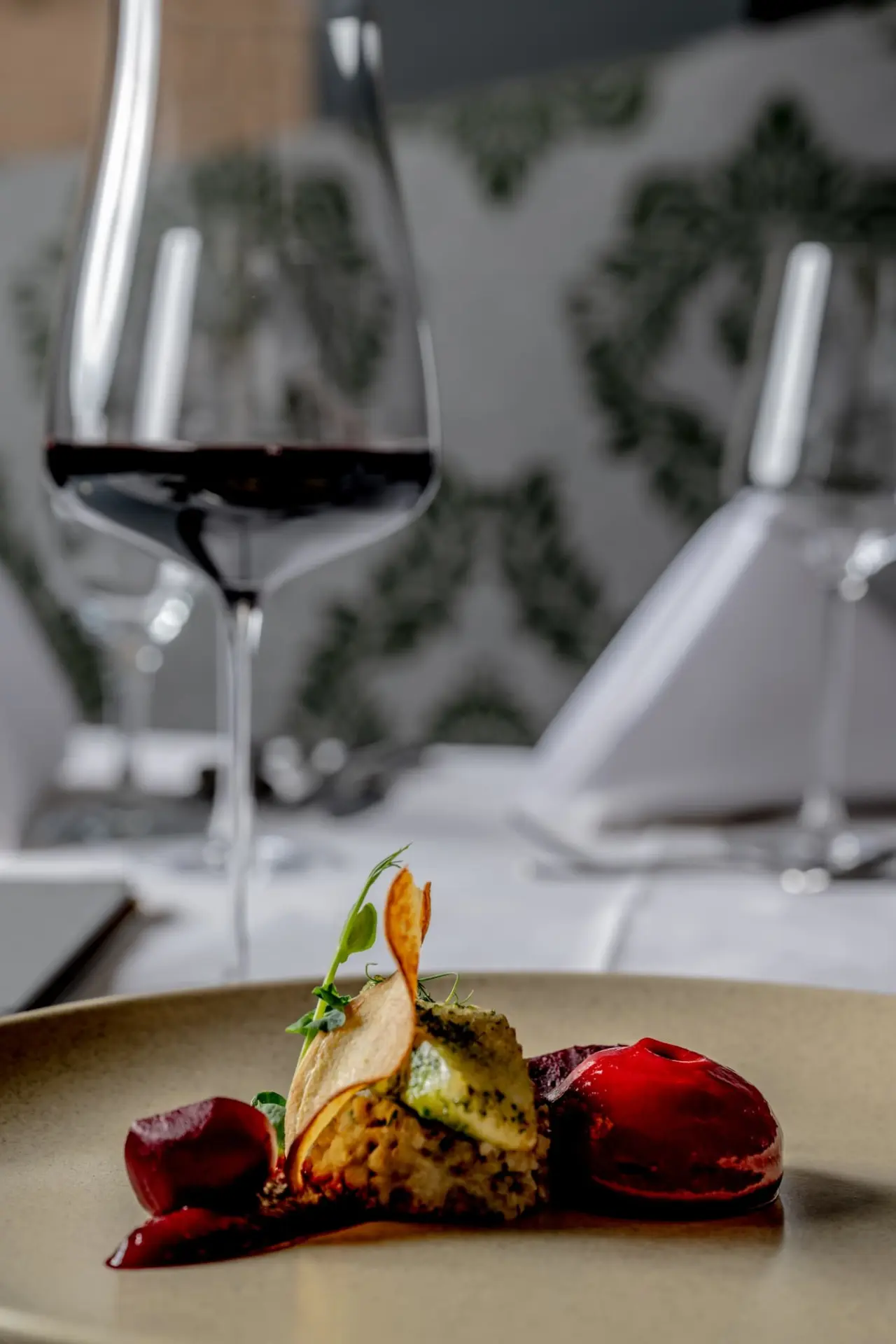 Fein angerichtetes Gourmet-Gericht mit Rote Bete und Wein im Restaurant des König Ludwig Inspiration SPA.
