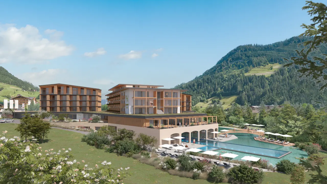 Moderne Architektur des Hotel Nesslerhof mit weitläufiger Poollandschaft und Alpenpanorama. Perfekt für Wellness & Erholung.
