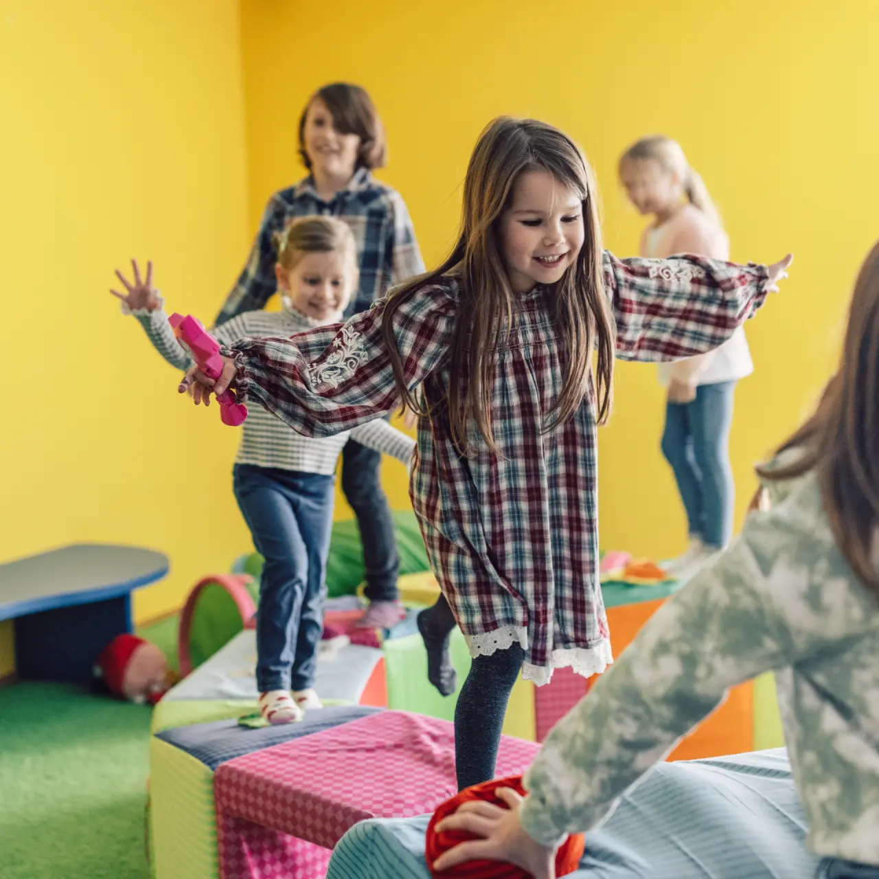Spielende Kinder im bunten Spielzimmer des Hotel Mooshaus. Fröhliche Atmosphäre im Familienhotel.