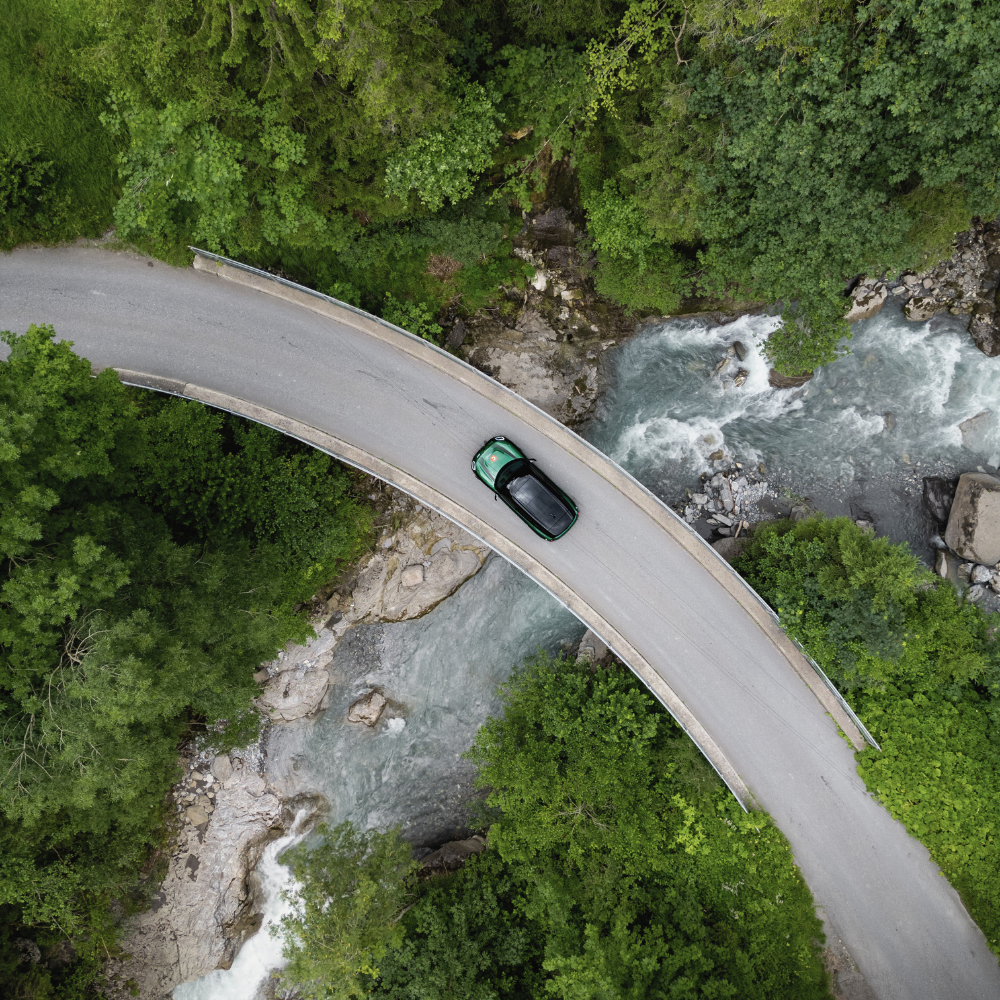 The Cambrian Adelboden in Adelboden – Grüne Natur mit Fluss und Brücke aus der Vogelperspektive | Wellnesshotel Berner Oberland