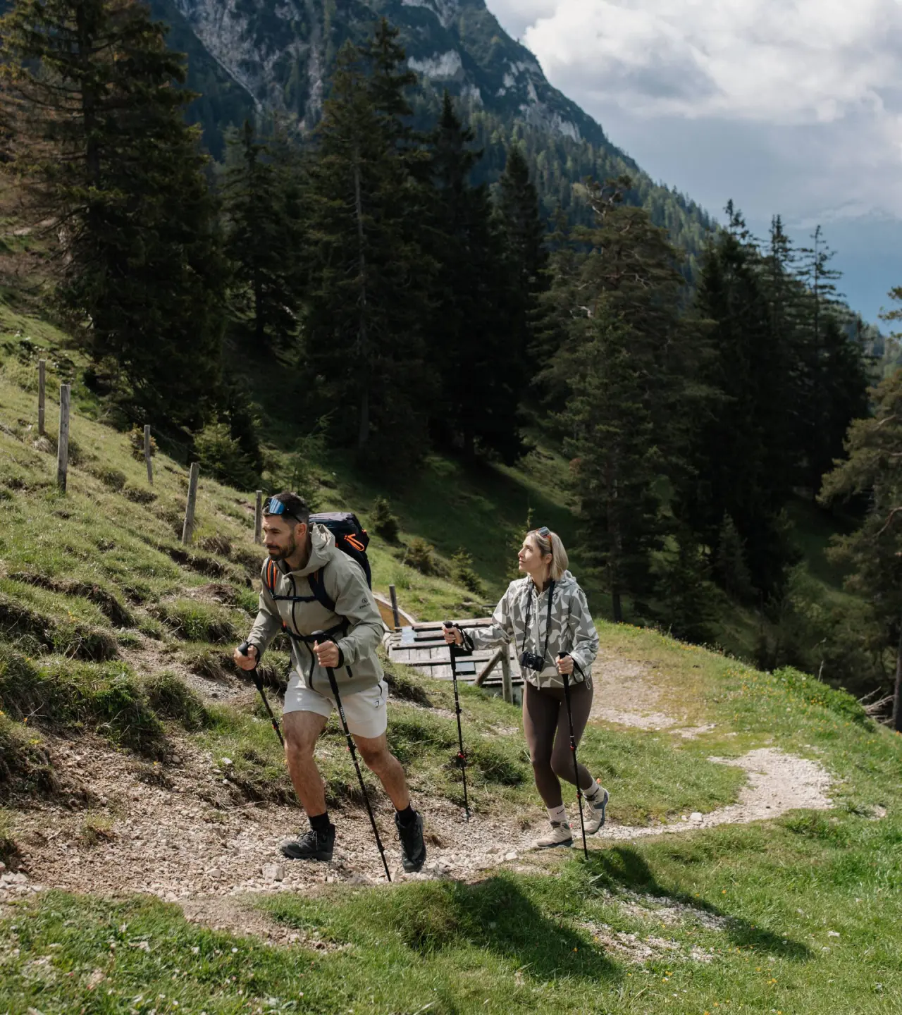 Wanderndes Paar mit Trekkingstöcken auf einem Bergpfad in den Alpen nahe DAS KRONTHALER****S.