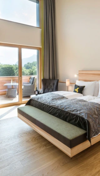 Helles Hotelzimmer mit Doppelbett, Balkon und Bergblick im Klosterhof - Alpine Hideaway & Spa.
