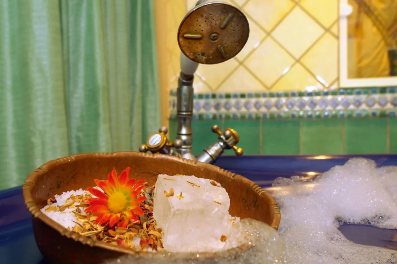 Entspannendes Schaumbad mit Badesalz, Blume und Kristall in der Badewanne im Strandhotel Heringsdorf.