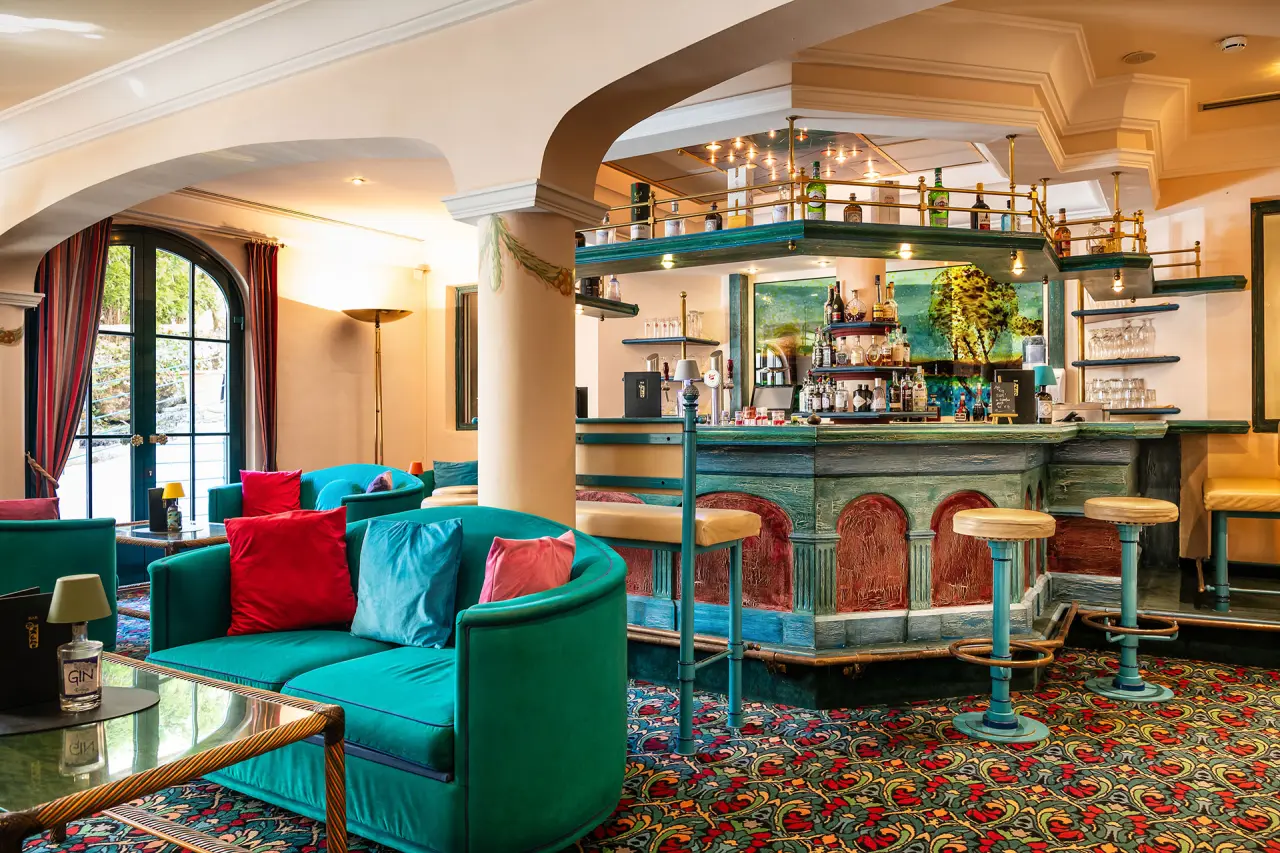 Gemütliche Hotelbar mit farbenfrohen Sitzgelegenheiten und rustikalem Tresen im Hotel Mitterwirt.