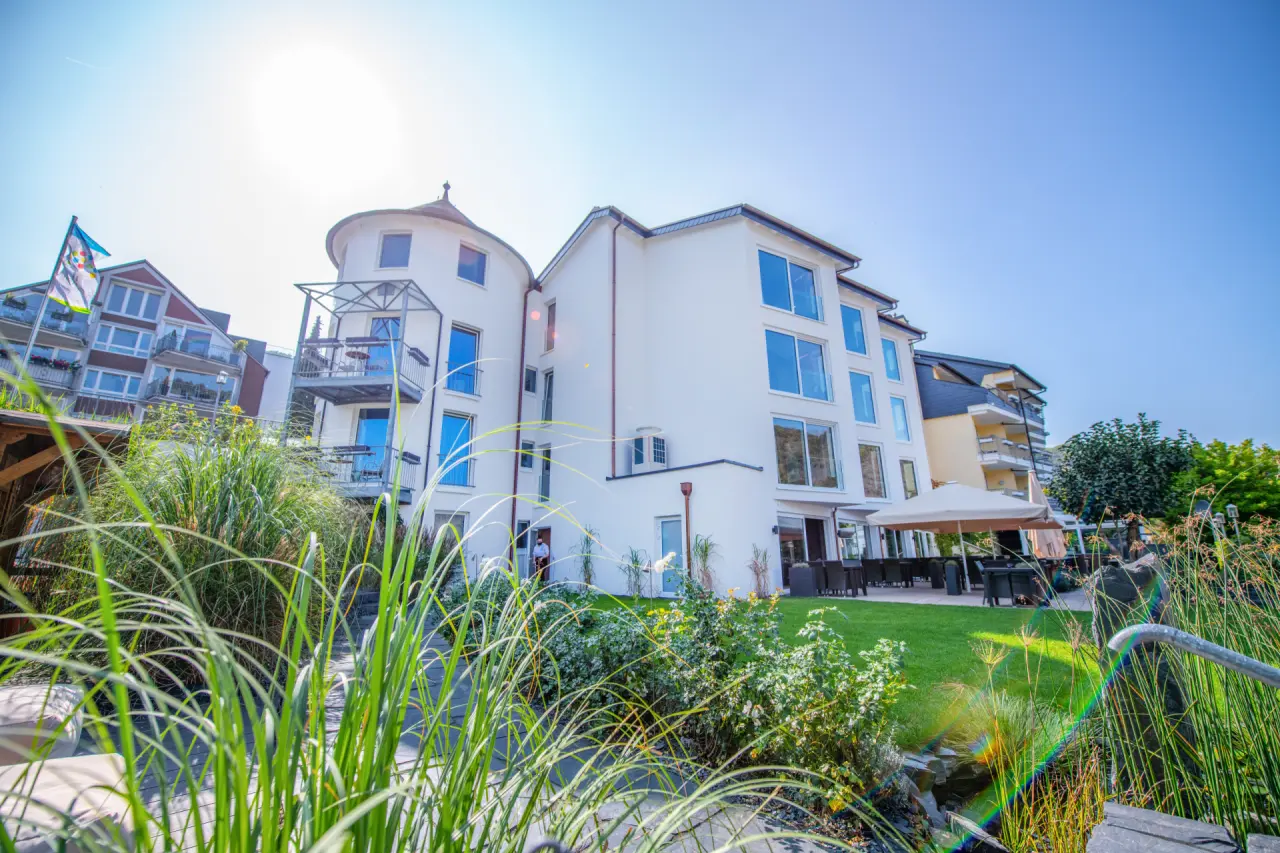Aussenansicht des Moselromantik Hotel Keßler-Meyer an einem sonnigen Tag mit moderner Architektur und gepflegtem Gartenbereich.