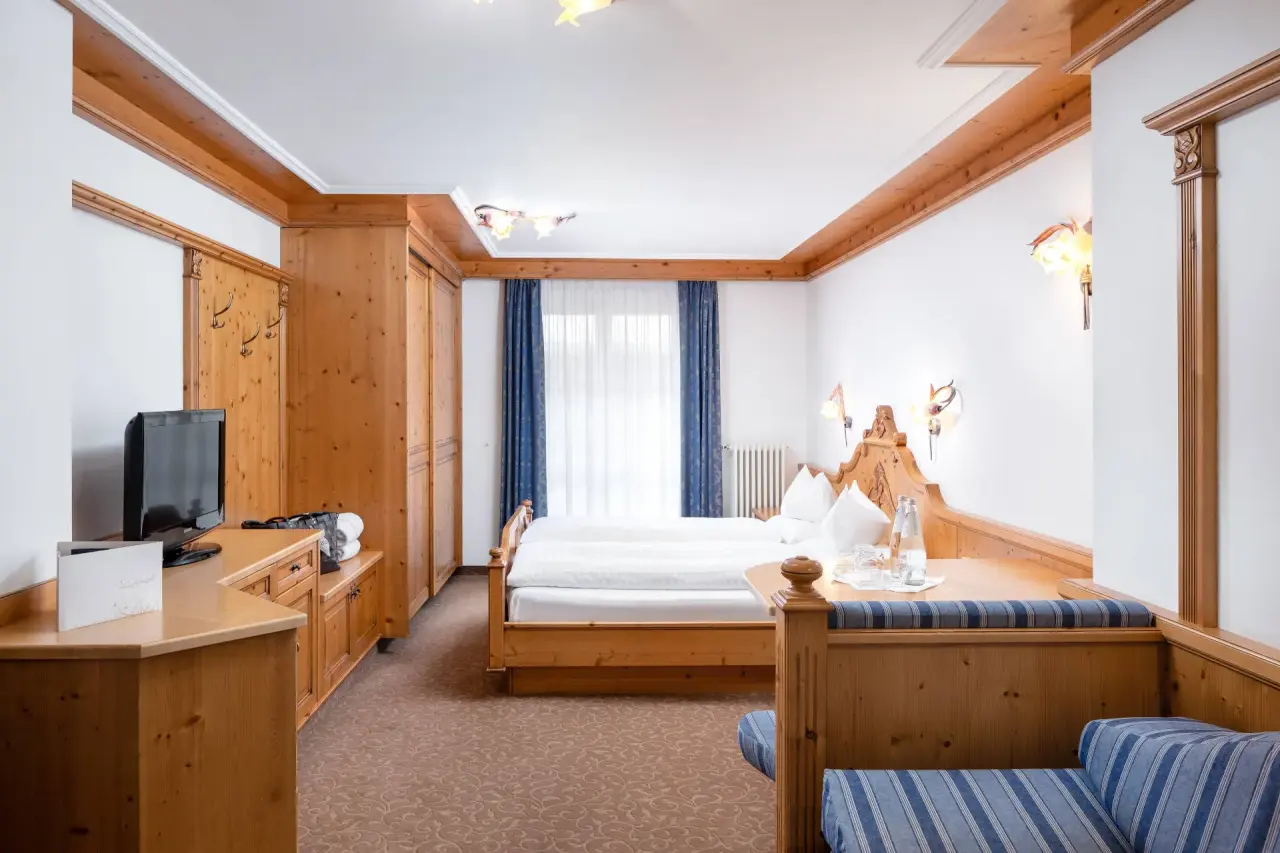 The Cacciatora Wellness & Beauty Hotel in Alba di Canazei – Traditionelles Doppelzimmer mit Holzmöbeln | Wellnesshotel Dolomiten