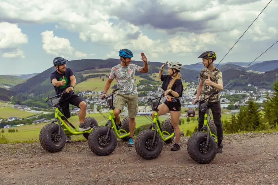 Gruppe auf Mountain-Scootern mit Panoramablick auf die Berge im Sauerland, nahe Kurhotel Hochsauerland 2010.