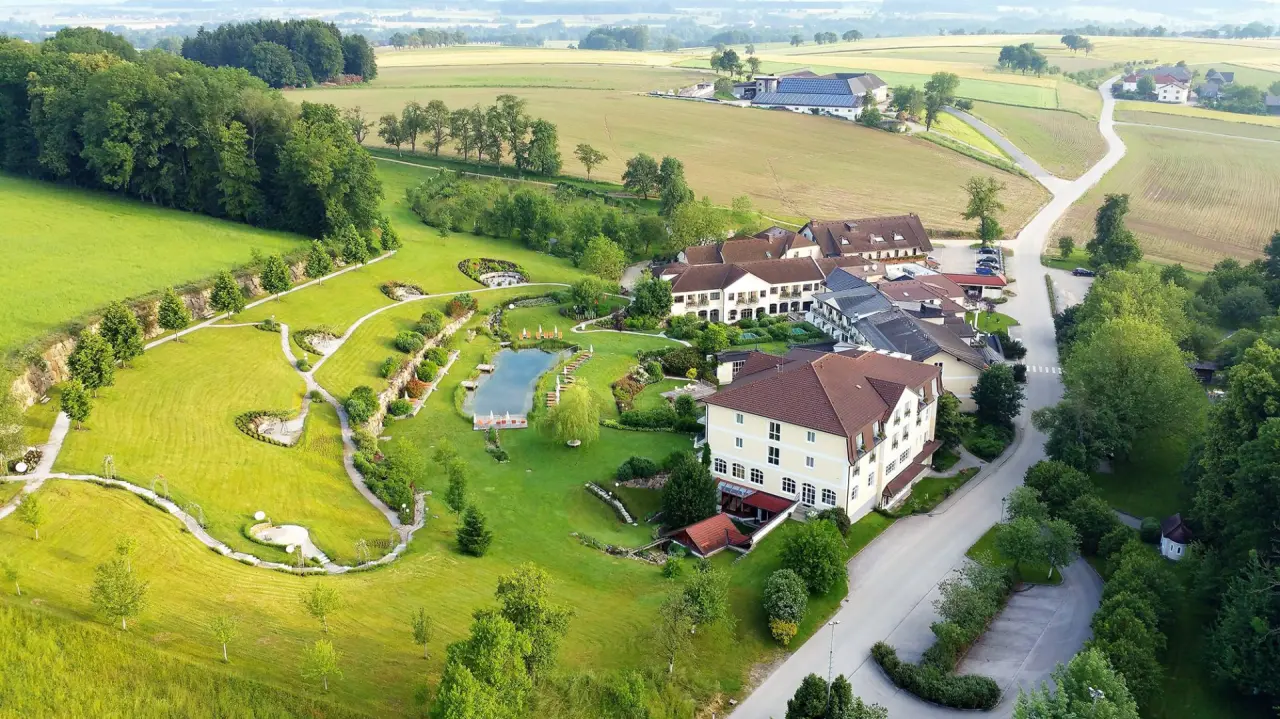Luftbild des RelaxResort Kothmühle mit Hotelanlage, weitläufigem Garten, Naturbadeteich und umliegender Landschaft.