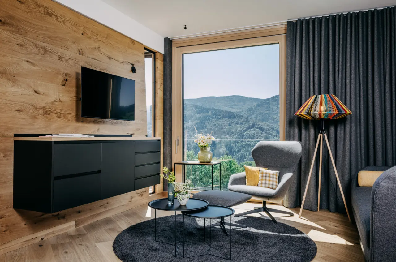 Moderne Suite im Luisenhöhe Gesundheitsresort Schwarzwald mit stilvollem Wohnbereich und Panoramablick auf die Berge.