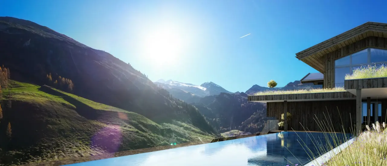 Infinity Pool mit atemberaubendem Bergpanorama und moderner Architektur im Hotel Alpenhof.