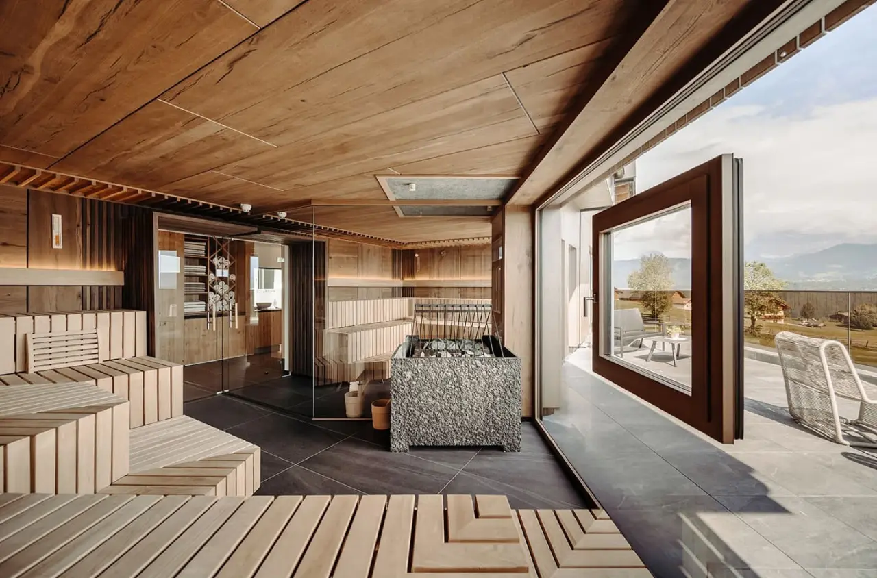 Moderne finnische Sauna mit Holzinterieur und Panoramablick auf die Berge im Hotel Waldfrieden.