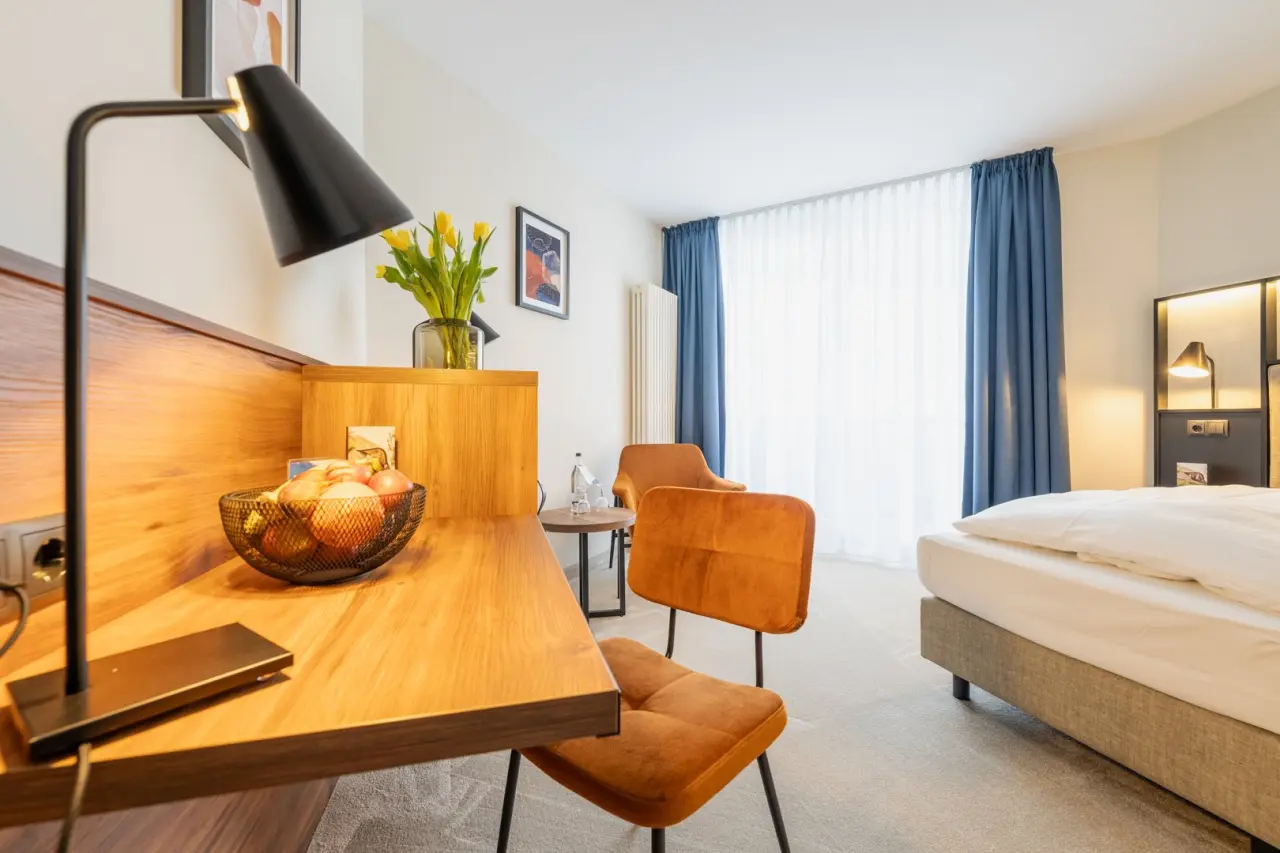 Komfortables Doppelzimmer mit Schreibtisch, Obstkorb und modernen Möbeln im Hotel Solthus am See.