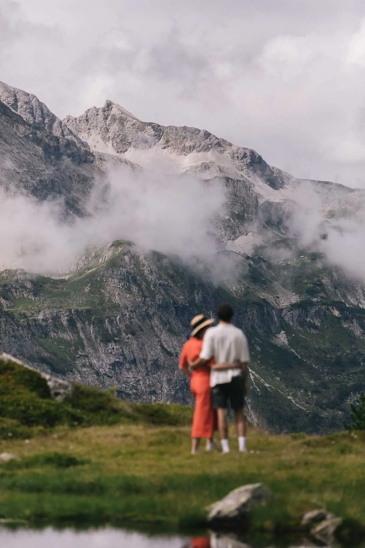 Romantisches Paar genießt den Ausblick auf majestätische, nebelverhangene Berge in der Umgebung des Hotel Steiner.